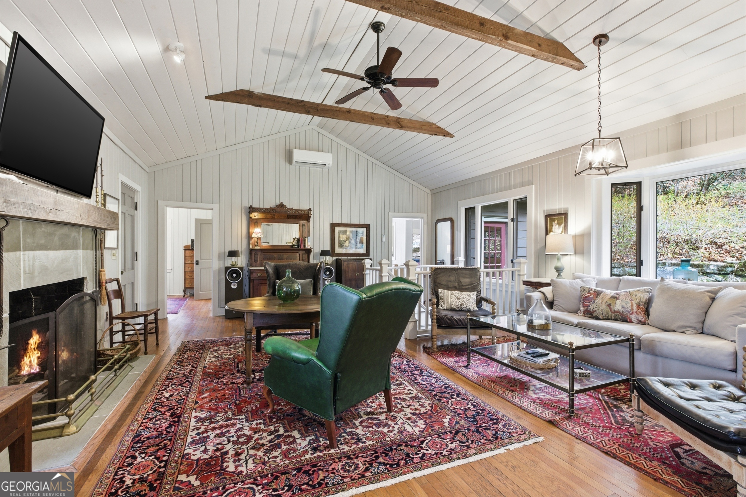 1921 Franklin Road Highlands, NC 28741 - Photo 15 of 72 a living room with furniture a flat screen tv and a fireplace