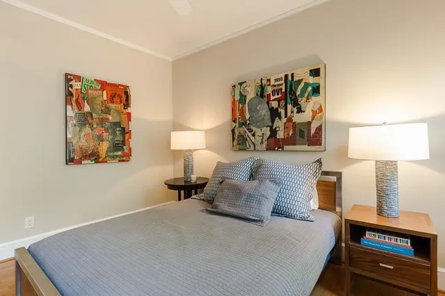 a bedroom with a bed and lamp