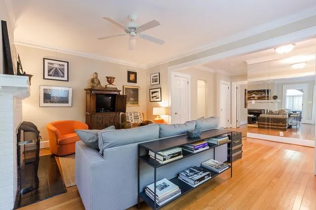 a living room with furniture fireplace and a window