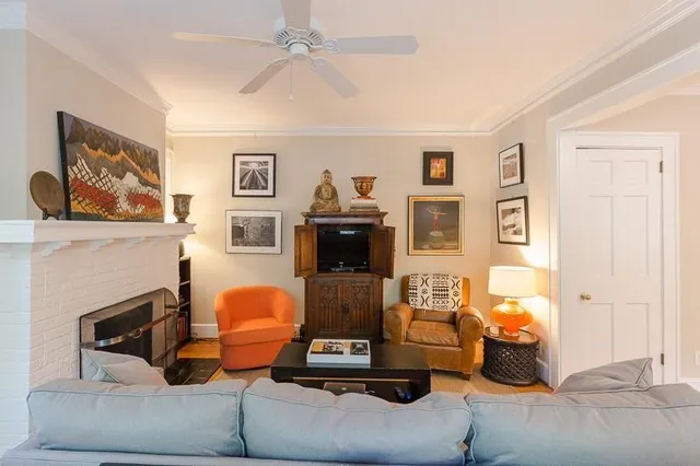 a living room with furniture and a fireplace