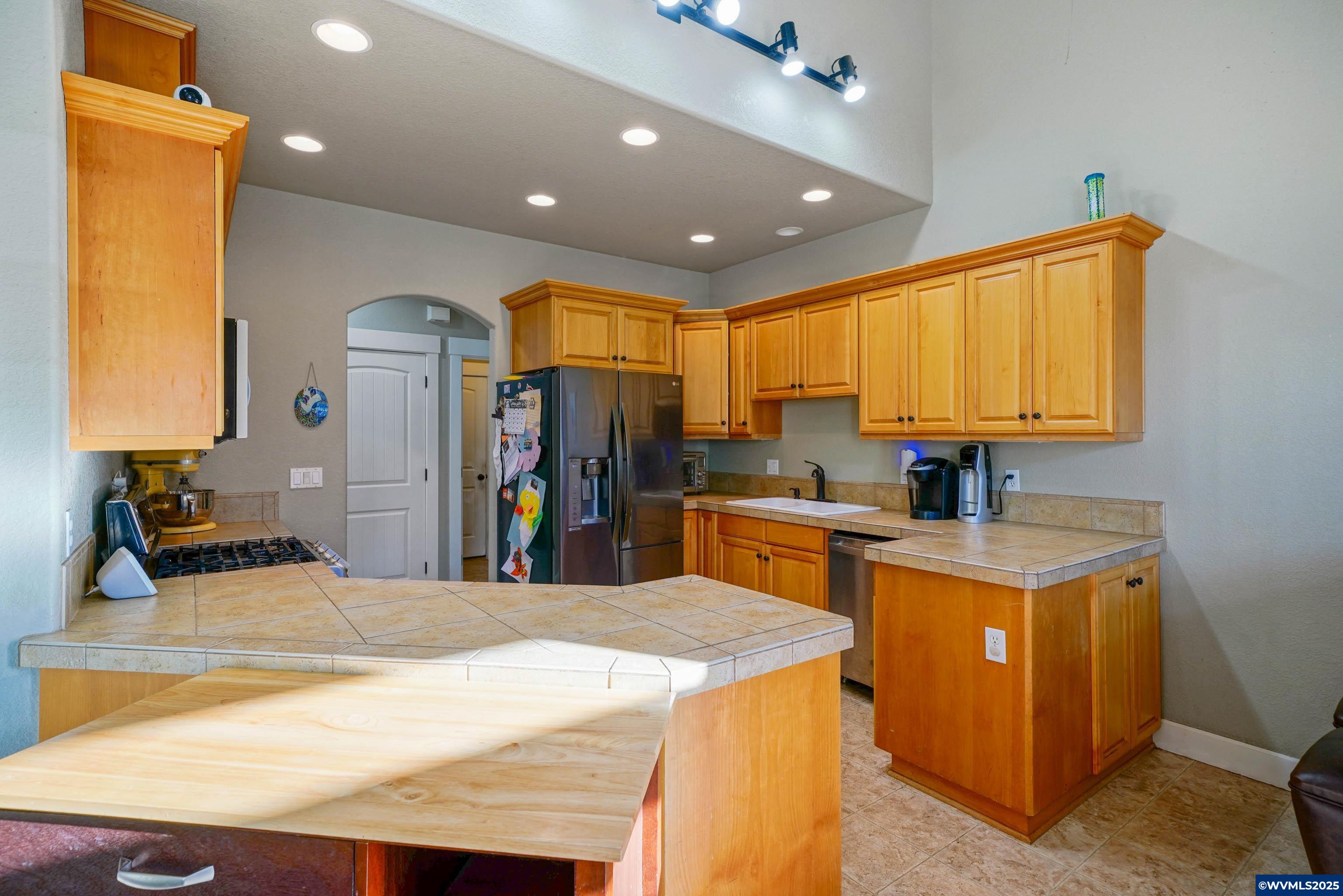 353 Northwest Reed Lane Dallas, OR 97338 - Photo 16 of 45 a kitchen with stainless steel appliances granite countertop sink stove and refrigerator