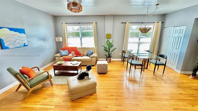 a living room with dining room and wooden floor