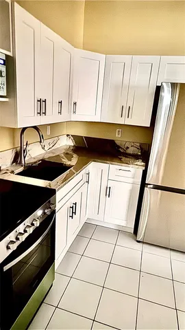 a kitchen with a stove a sink and a refrigerator