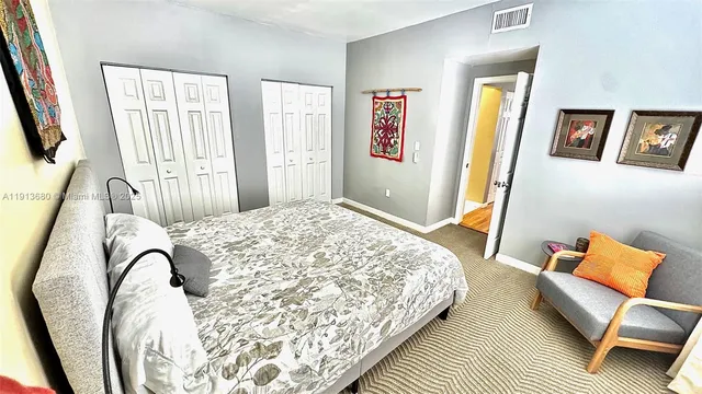 a bedroom with a bed and a painting on the wall