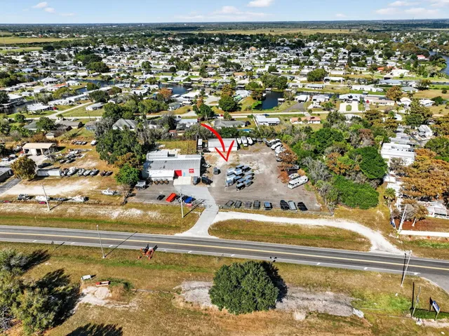 an aerial view of residential houses with outdoor space and lake view