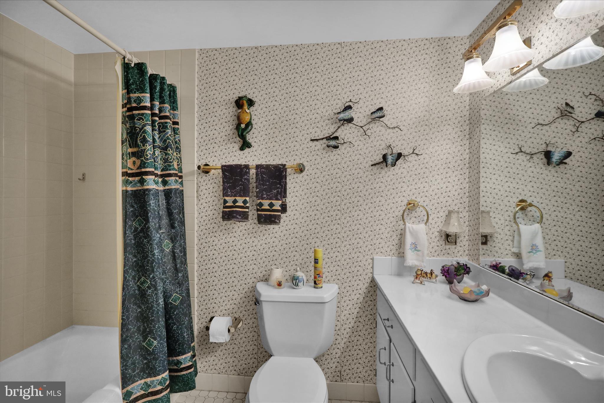 1375 Pershing Boulevard, Unit 201 Reading, PA 19607 - Photo 18 of 24 a bathroom with a sink a toilet and shower curtain