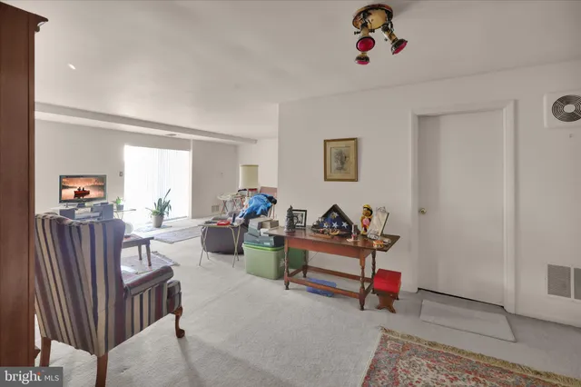 a view of a livingroom with dining room and natural light