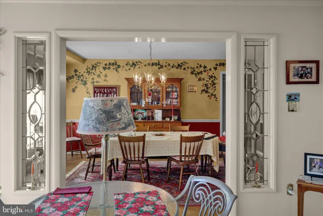a view of a dining room with furniture and chandelier