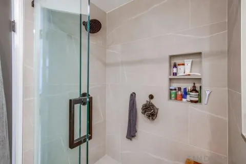 a bathroom with a shower and a mirror