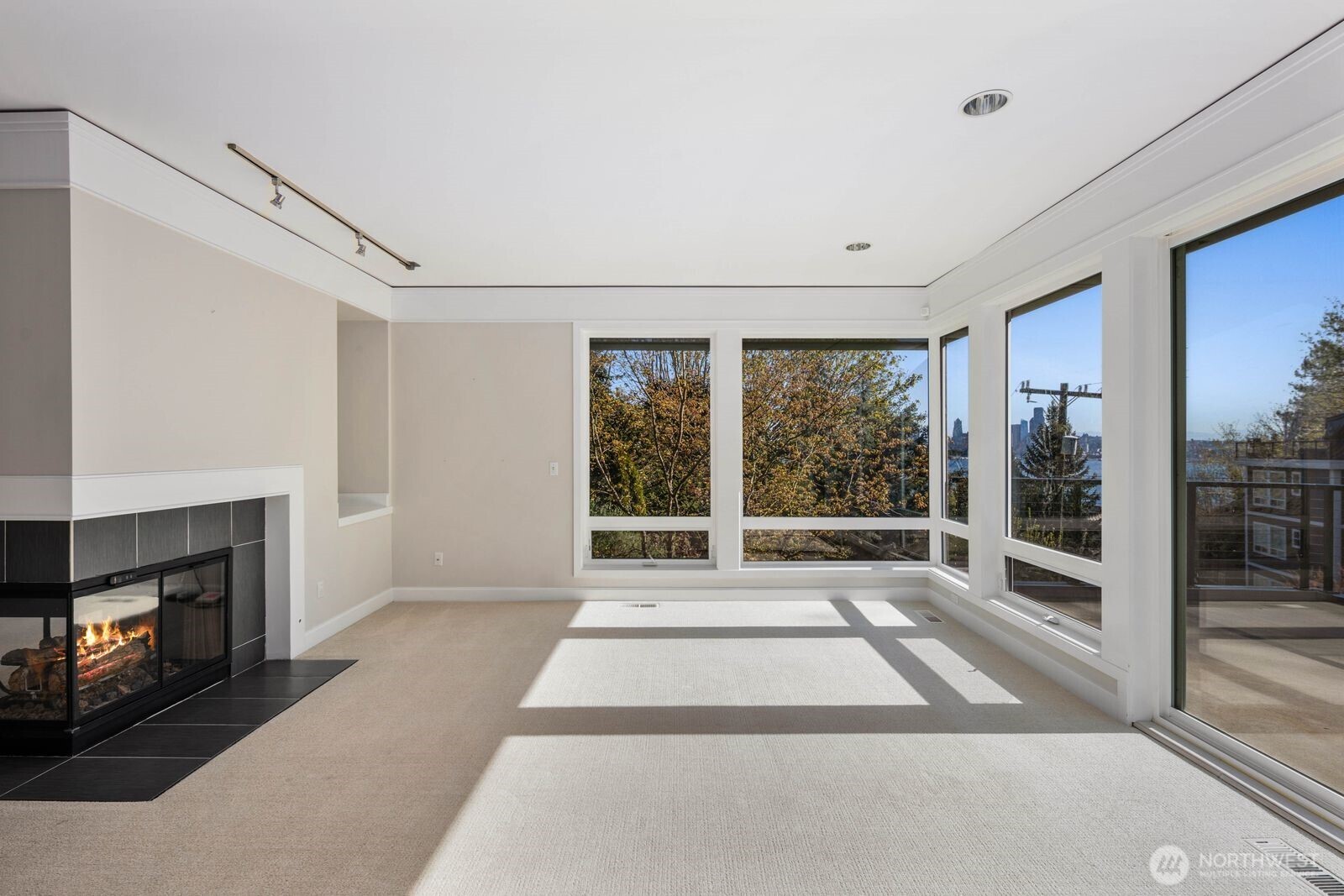 1717 Ferry Avenue Southwest Seattle, WA 98116 - Photo 10 of 40 a living room with a large window and a fireplace