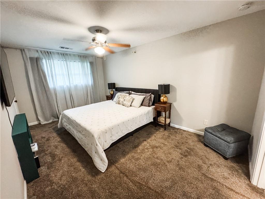 230 Chaffin Ridge Trace Roswell, GA 30075 - Photo 12 of 23 a bedroom with a bed and a chandelier