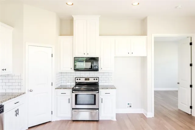 a kitchen with stainless steel appliances a refrigerator stove and microwave