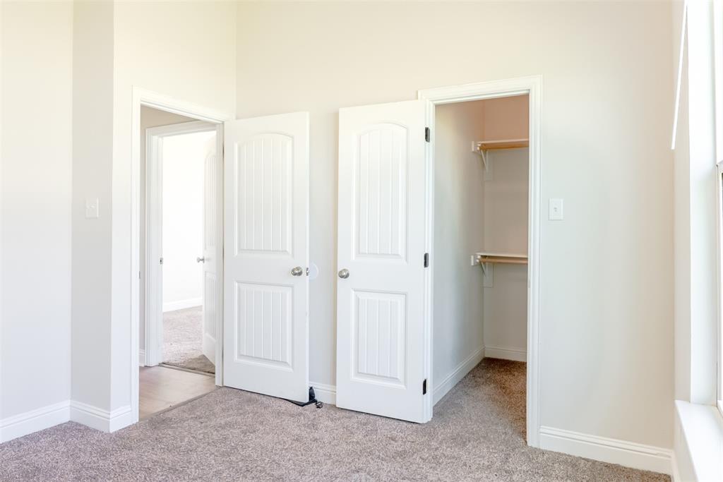 16806 Fm 3486 Terrell, TX 75160 - Photo 15 of 21 Unfurnished bedroom featuring light carpet and a walk in closet