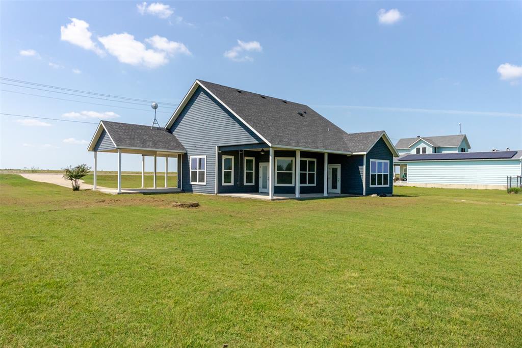 16806 Fm 3486 Terrell, TX 75160 - Photo 20 of 21 Back of house with a yard, a patio, and a shingled roof
