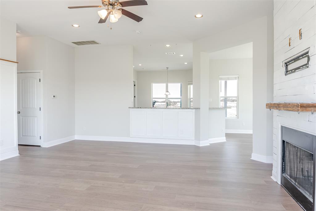 16806 Fm 3486 Terrell, TX 75160 - Photo 5 of 21 Unfurnished living room with recessed lighting, light wood finished floors, a large fireplace, and ceiling fan