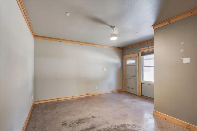 an empty room with windows and closet