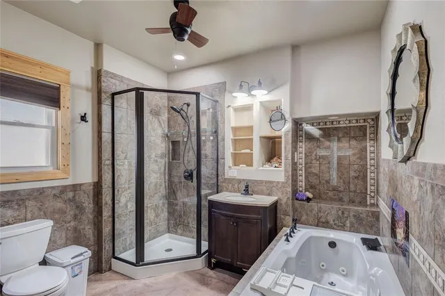 a bathroom with a bathtub shower sink mirror and toilet