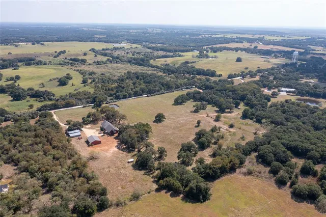 an aerial view of a house with a mountain