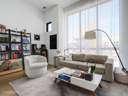 a living room with furniture and a book shelf