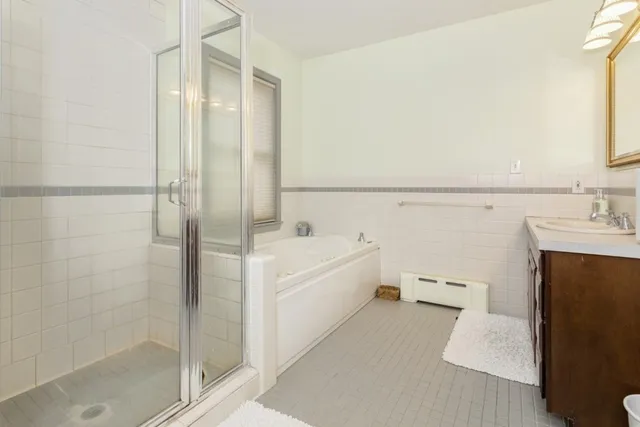 a bathroom with a bathtub and a shower