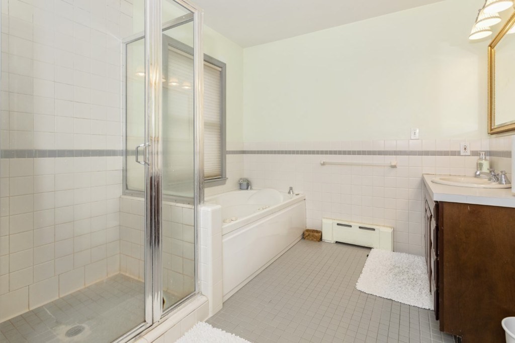 8 Castle Road Nahant, MA 01908 - Photo 17 of 32 a bathroom with a bathtub and a shower
