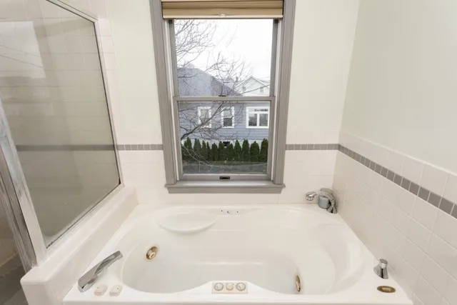 a white bath tub sitting next to a window