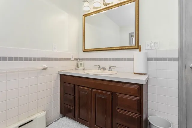 a bathroom with a sink vanity and a mirror