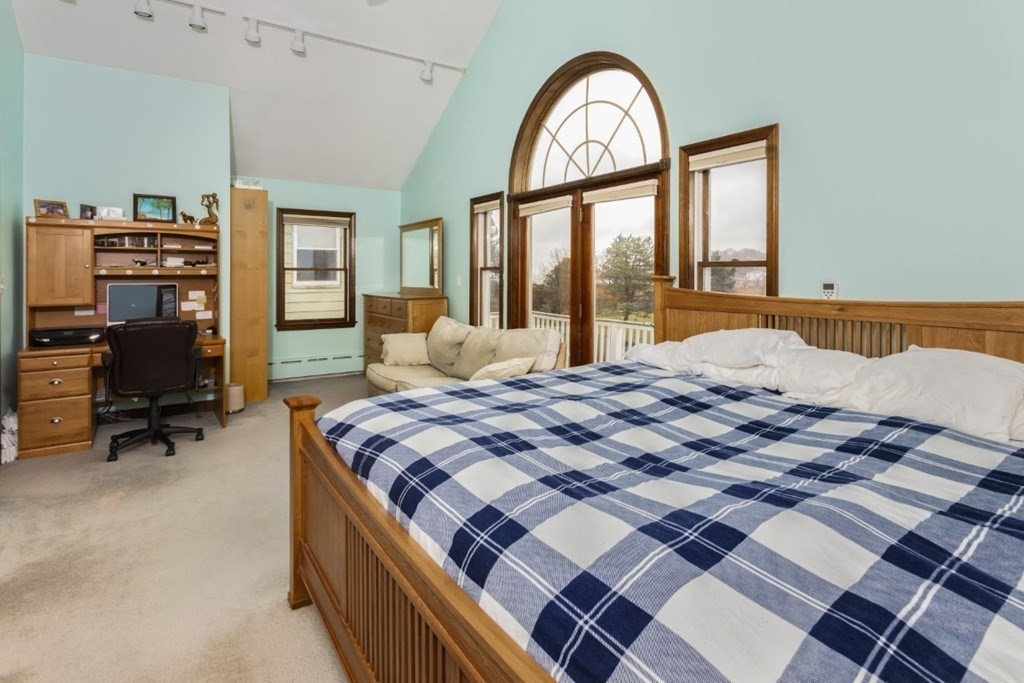8 Castle Road Nahant, MA 01908 - Photo 22 of 32 a bedroom with a bed a table and large window