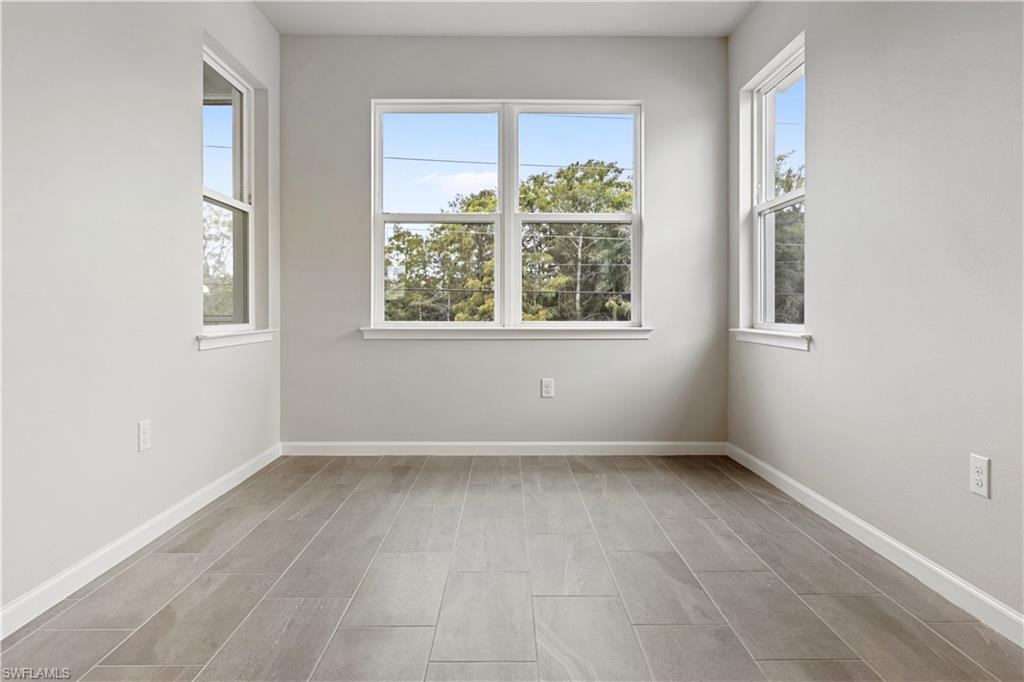 4670 Arboretum Circle, Unit 203 Naples, FL 34112 - Photo 16 of 33 an empty room with windows