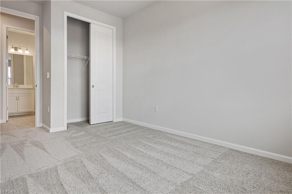 4670 Arboretum Circle, Unit 203 Naples, FL 34112 - Photo 30 of 33 an empty room with closet and a bathroom