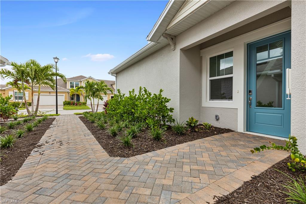 4670 Arboretum Circle, Unit 203 Naples, FL 34112 - Photo 8 of 33 a front view of a house with garden