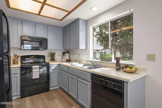 a kitchen with a sink cabinets and window