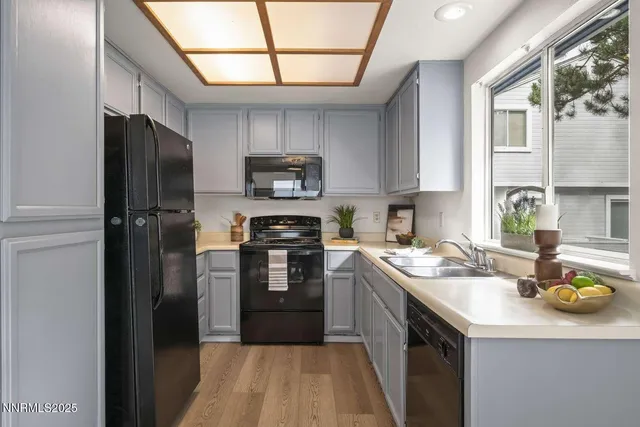 a kitchen with a sink appliances and cabinets
