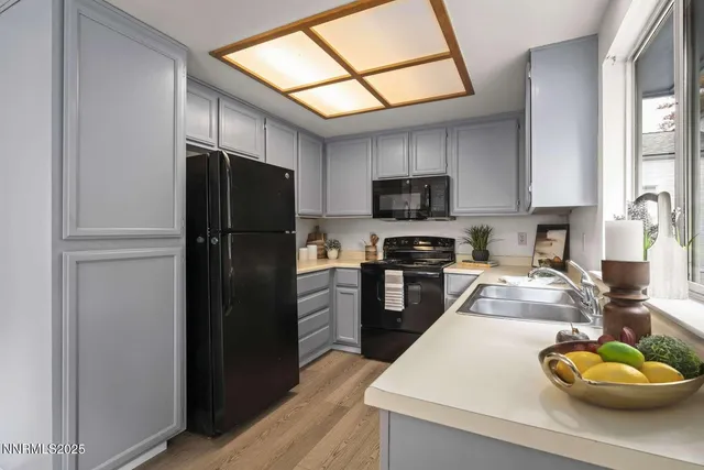 a kitchen with a refrigerator a stove a microwave and cabinets