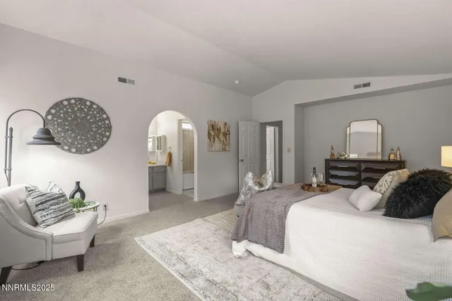 a bedroom with a bed mirror and window