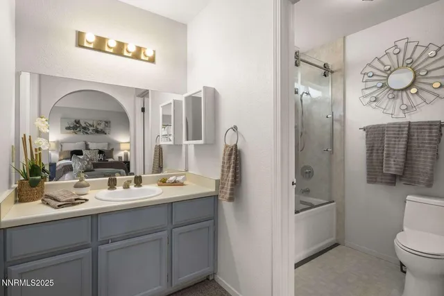 a bathroom with a double vanity sink toilet and shower