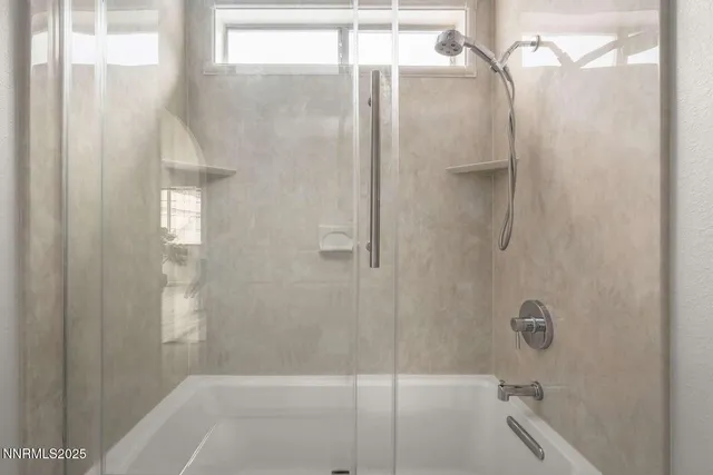 a bathroom with a glass shower door