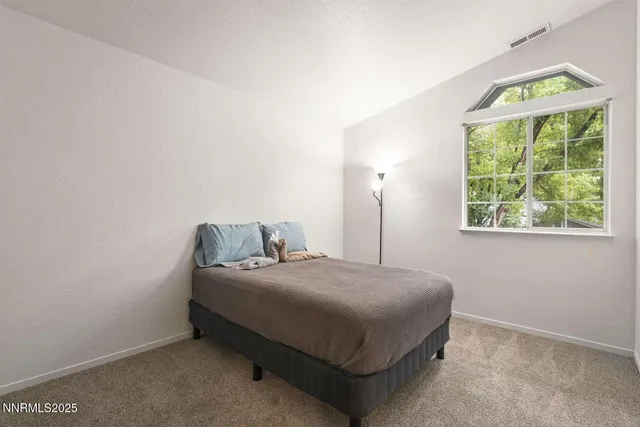 a bedroom with a bed and window