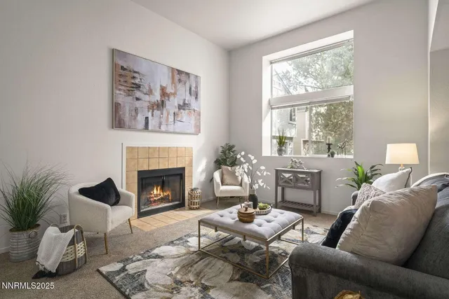 a living room with furniture a window and a fireplace