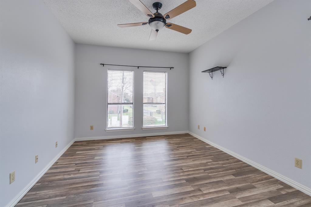 2100 Randy Snow Road, Unit 412 Arlington, TX 76011 - Photo 20 of 32 a view of an empty room with wooden floor and a window