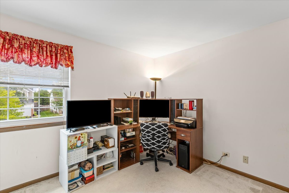 808 Violet Circle Naperville, IL 60540 - Photo 13 of 31 a view of a workspace with furniture and a flat screen tv