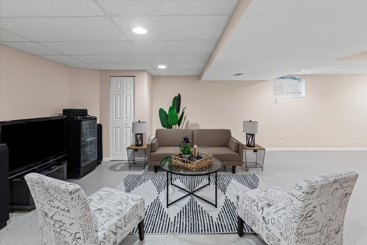 808 Violet Circle Naperville, IL 60540 - Photo 16 of 31 a living room with furniture a rug and a flat screen tv