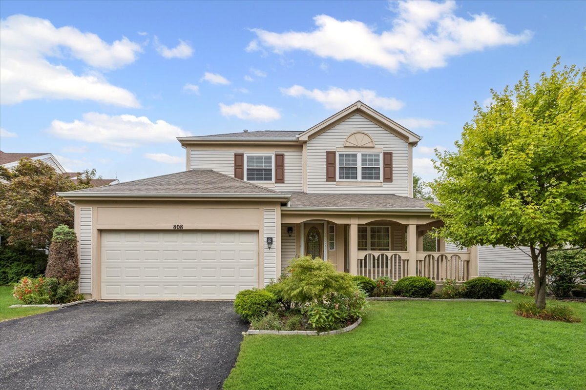 808 Violet Circle Naperville, IL 60540 - Photo 28 of 31 a front view of a house with a garden and yard