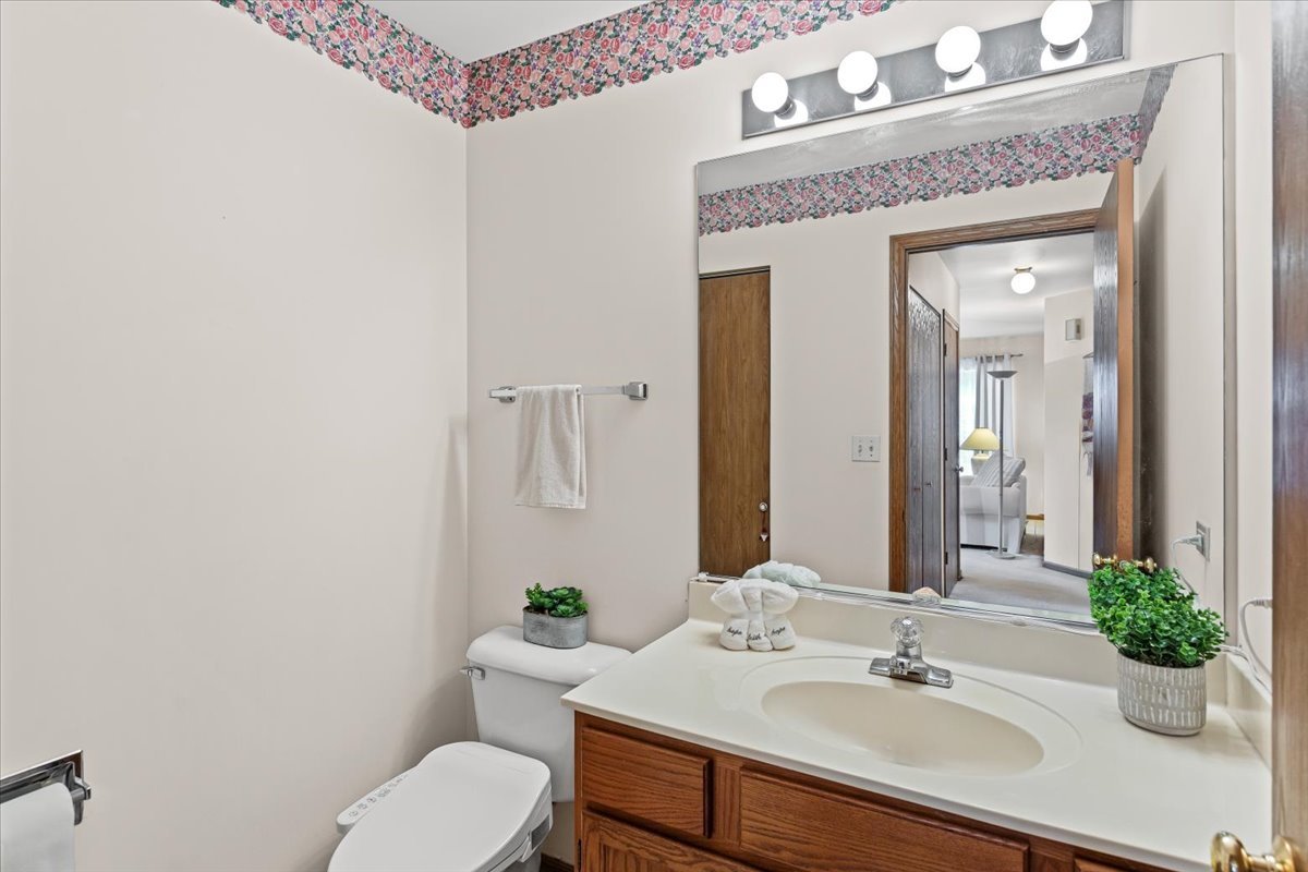 808 Violet Circle Naperville, IL 60540 - Photo 9 of 31 a bathroom with a sink vanity mirror and toilet