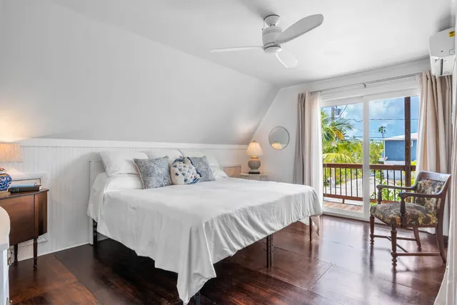 a large bed sitting in a bedroom next to a window