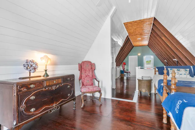 a view of a yard with plants and palm trees