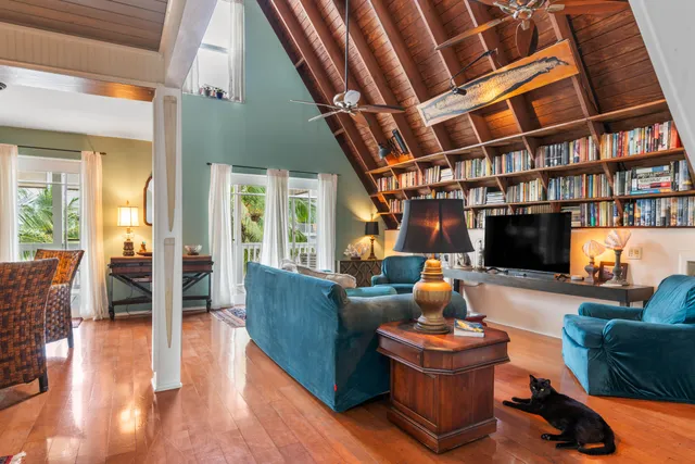 a living room with furniture a rug and a chandelier