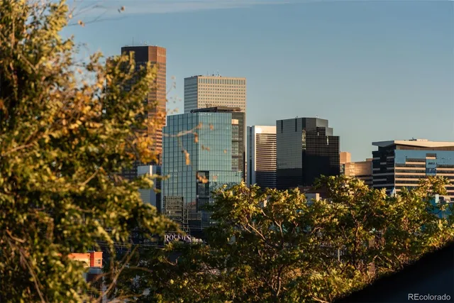 a terrace of a house with wooden floor and city view