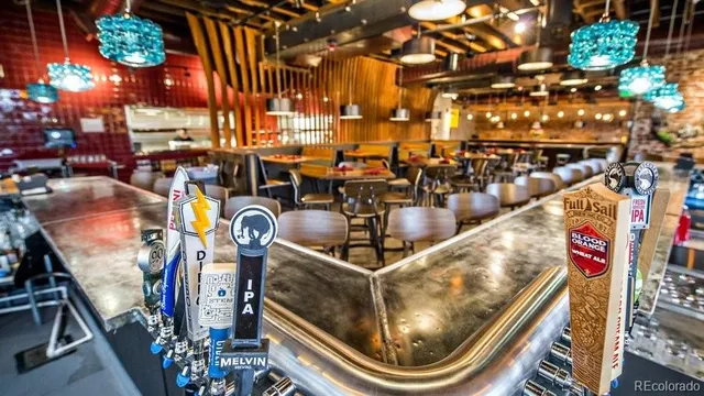 an outdoor space with lots of tables and chairs