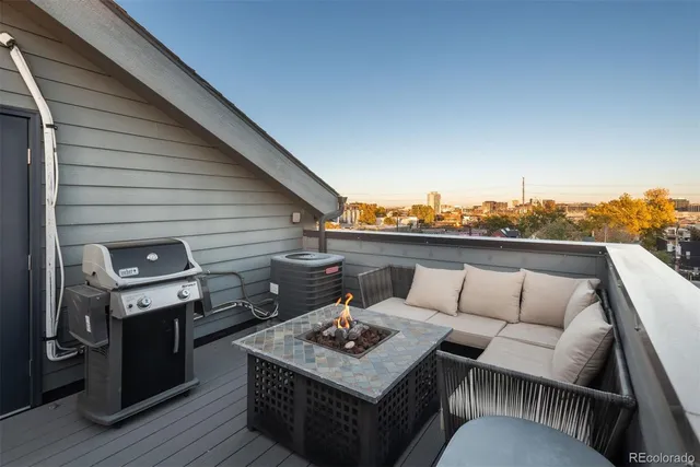 a balcony with furniture and wooden floor
